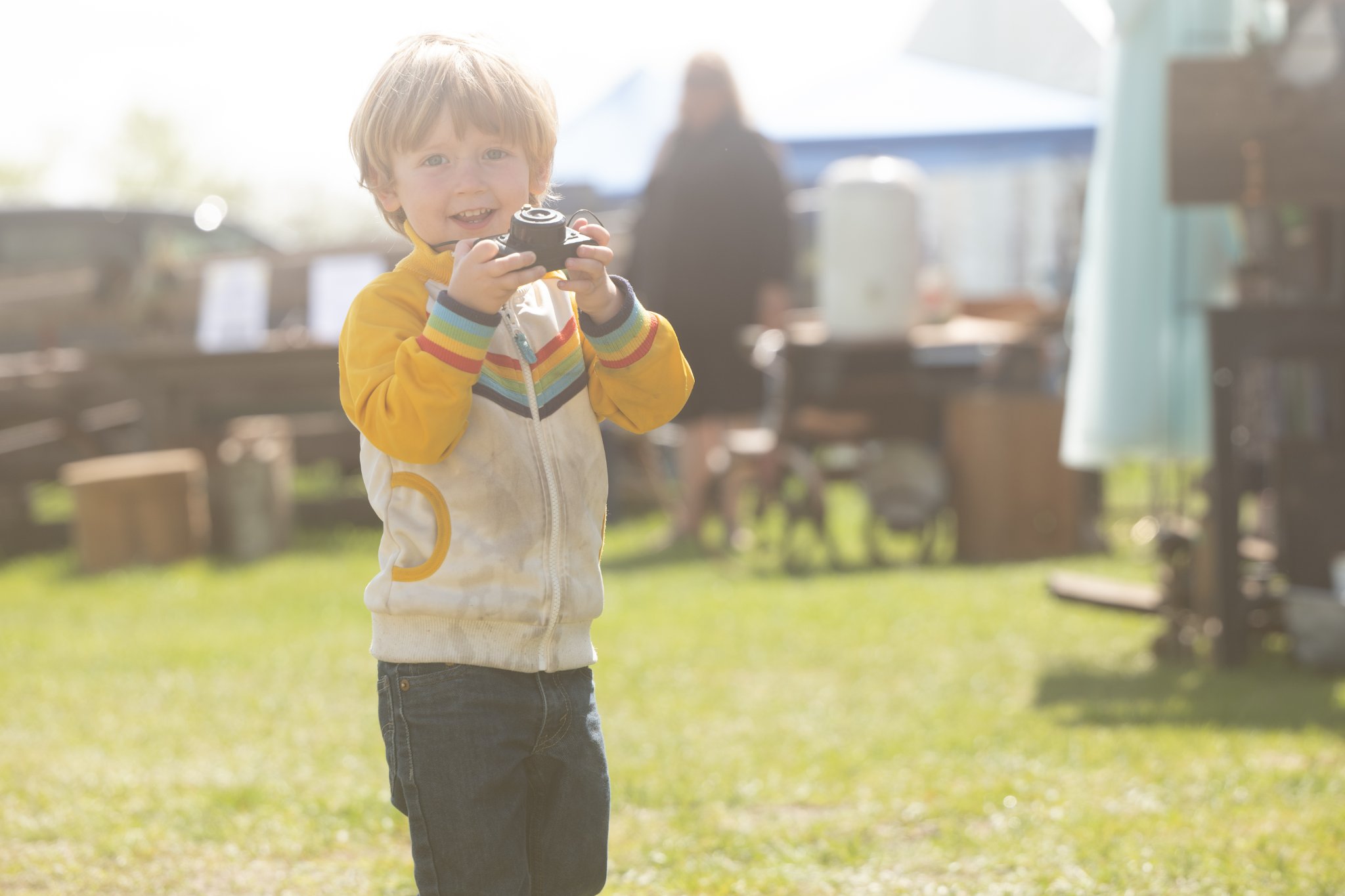 Young boy with camera outdoors