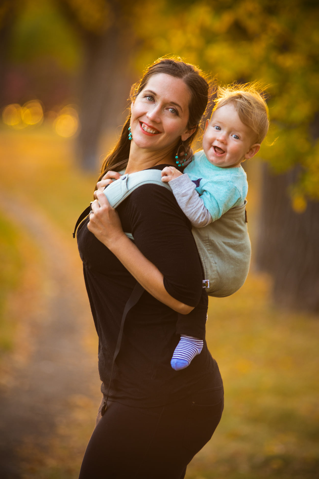 Mother holding baby in golden hour lighting